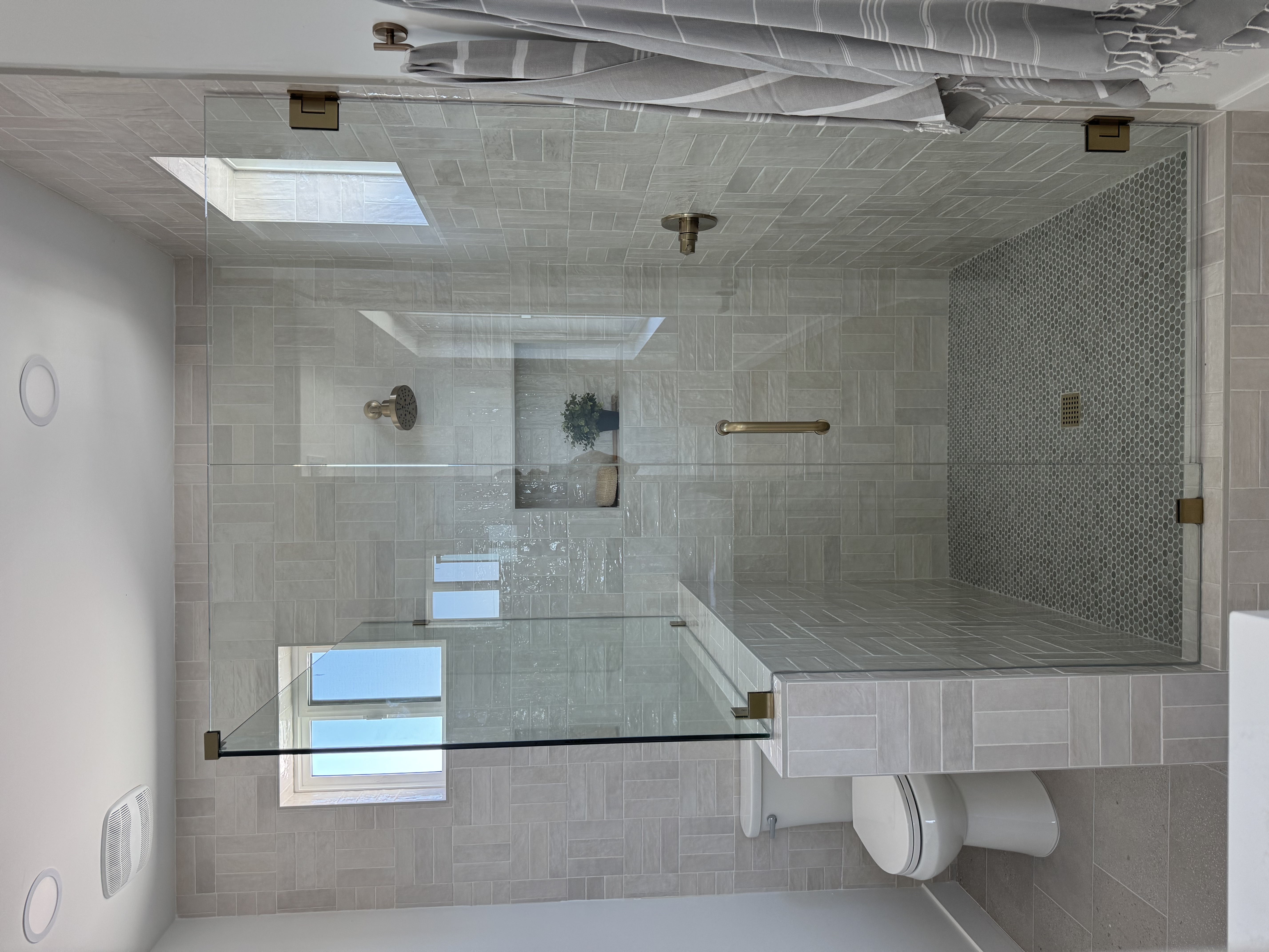 Clean and simple guest bathroom remodel in Gilbert AZ with updated tile, vanity, and modern fixtures