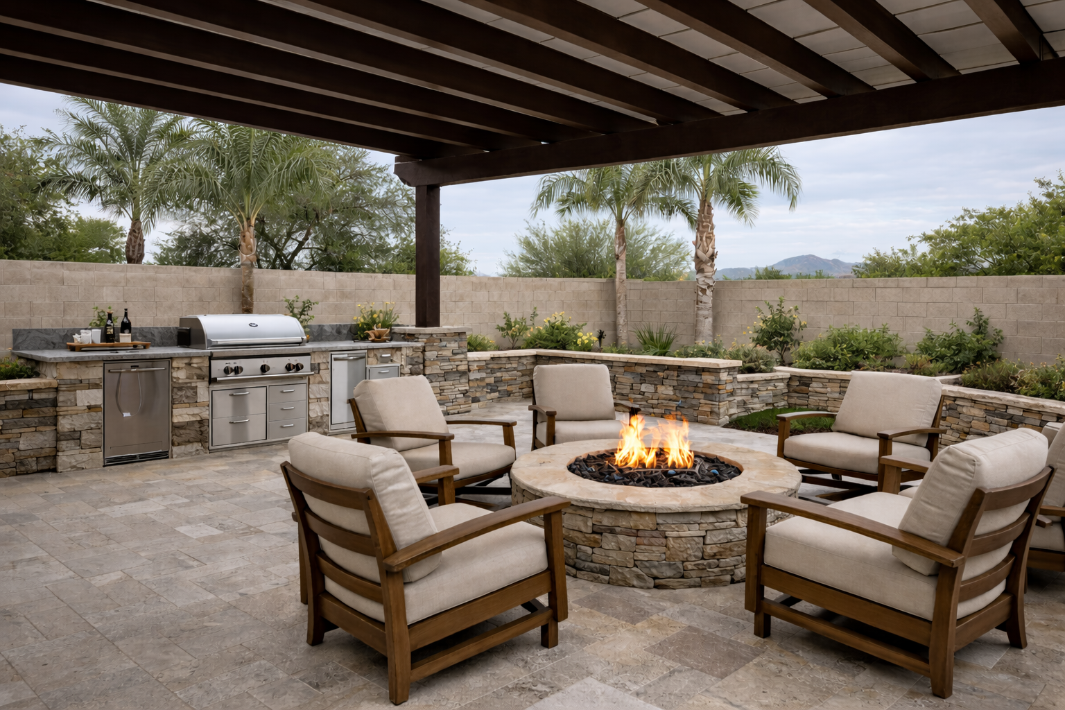 Travertine paver patio with built-in outdoor kitchen, pergola, and gas fire pit in Queen Creek AZ backyard