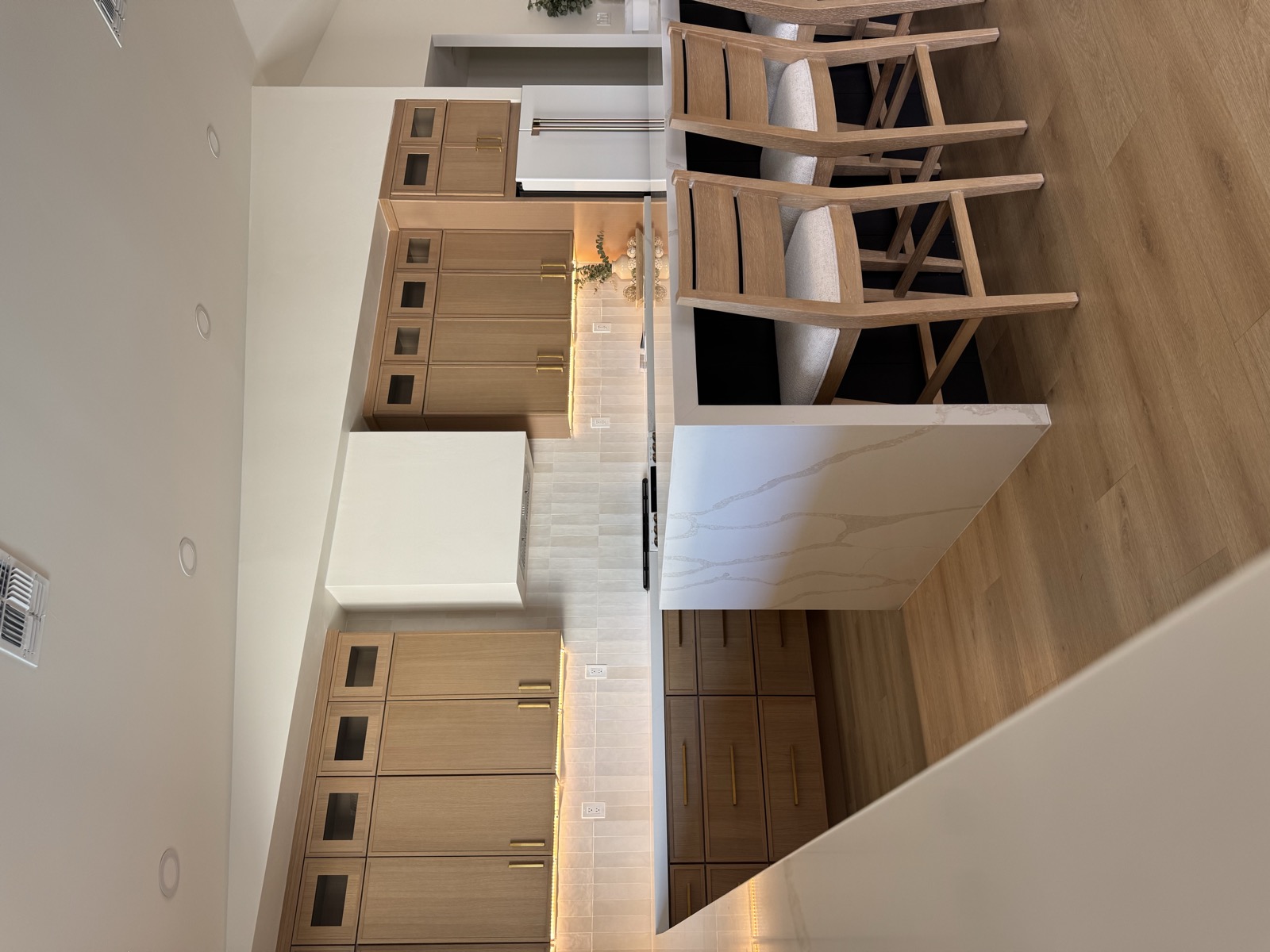 Natural modern kitchen in Scottsdale AZ with clean hard flooring and warm finishes