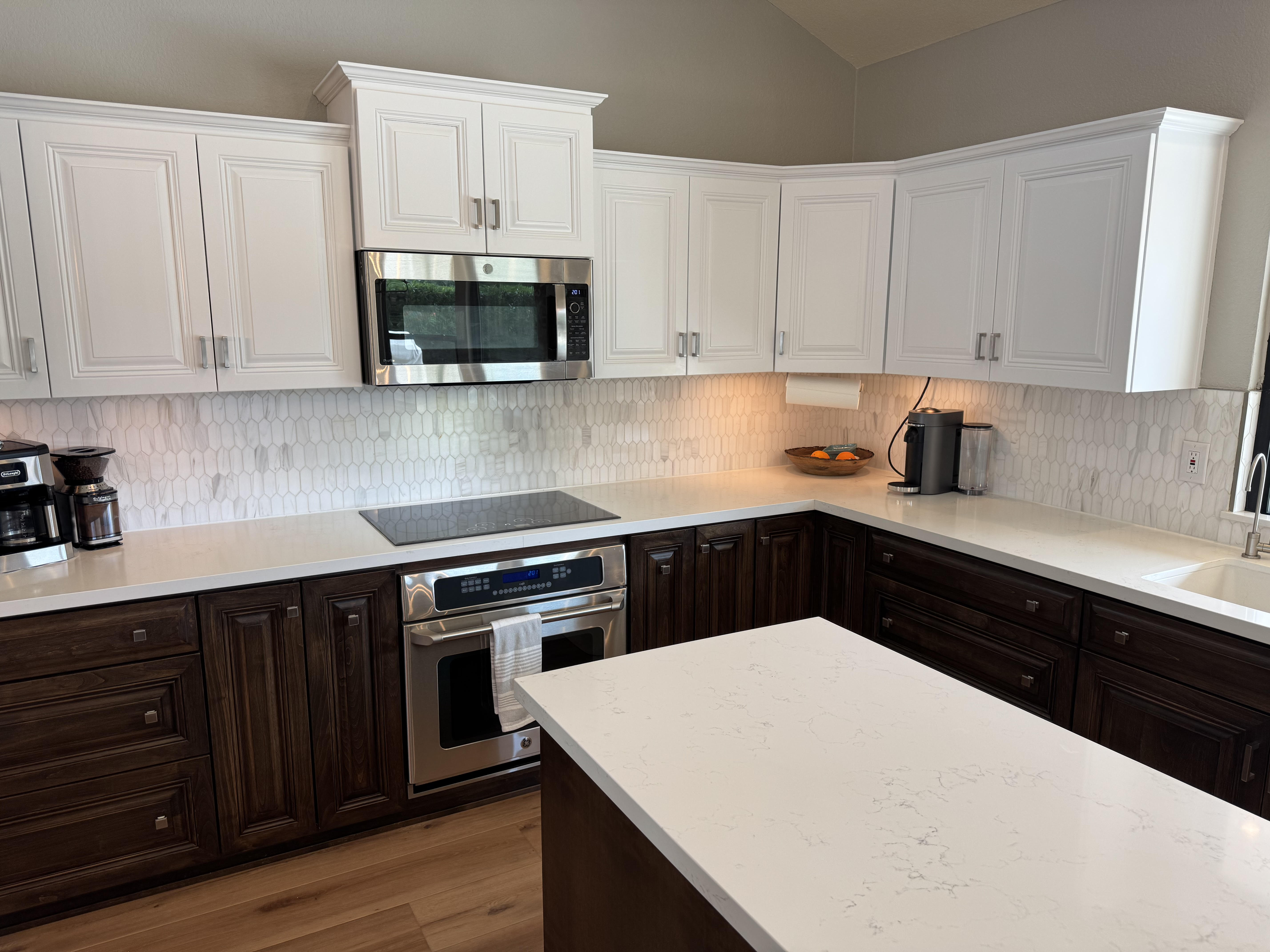 Modern two-tone kitchen remodel with white uppers, dark lowers, and quartz countertops in Scottsdale AZ